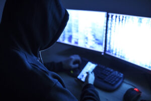 hooded man at computer