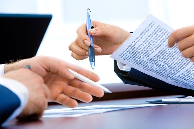 hands of two people signing documents pa now allows remote notary services